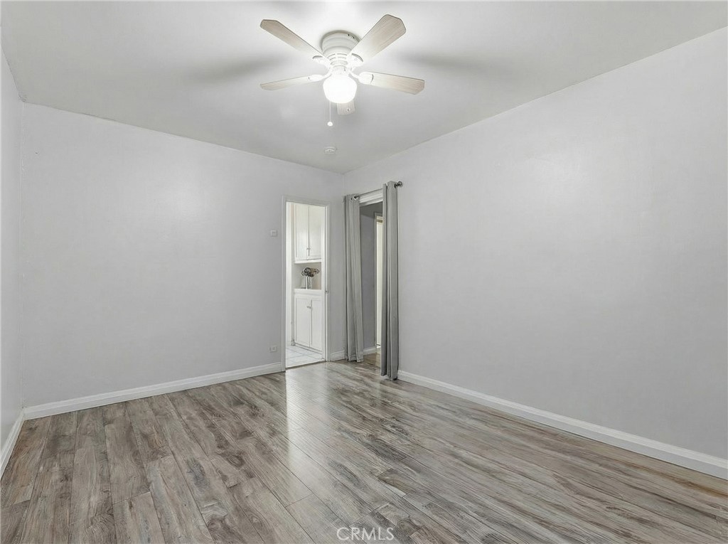 12817 Zeus Avenue Norwalk, CA 90650 - Photo 14 of 36 a view of an empty room with wooden floor