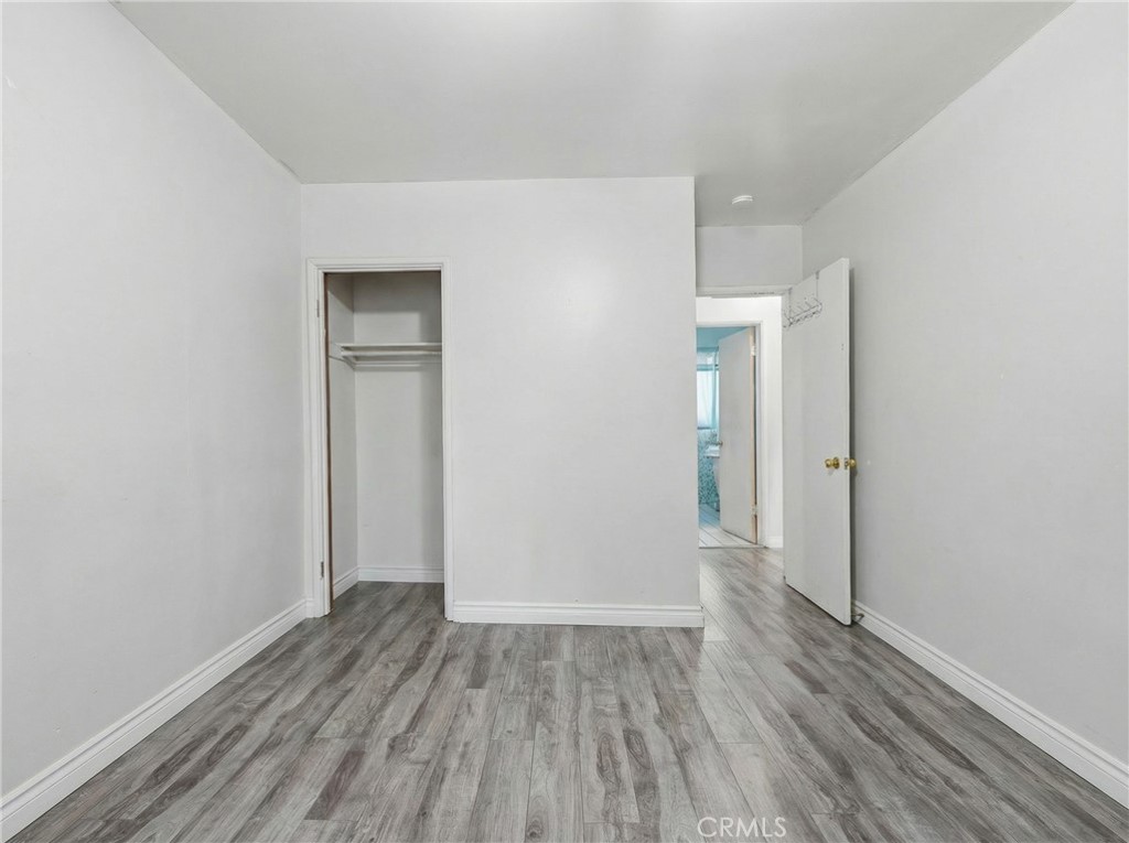 12817 Zeus Avenue Norwalk, CA 90650 - Photo 16 of 36 a view of an empty room with wooden floor