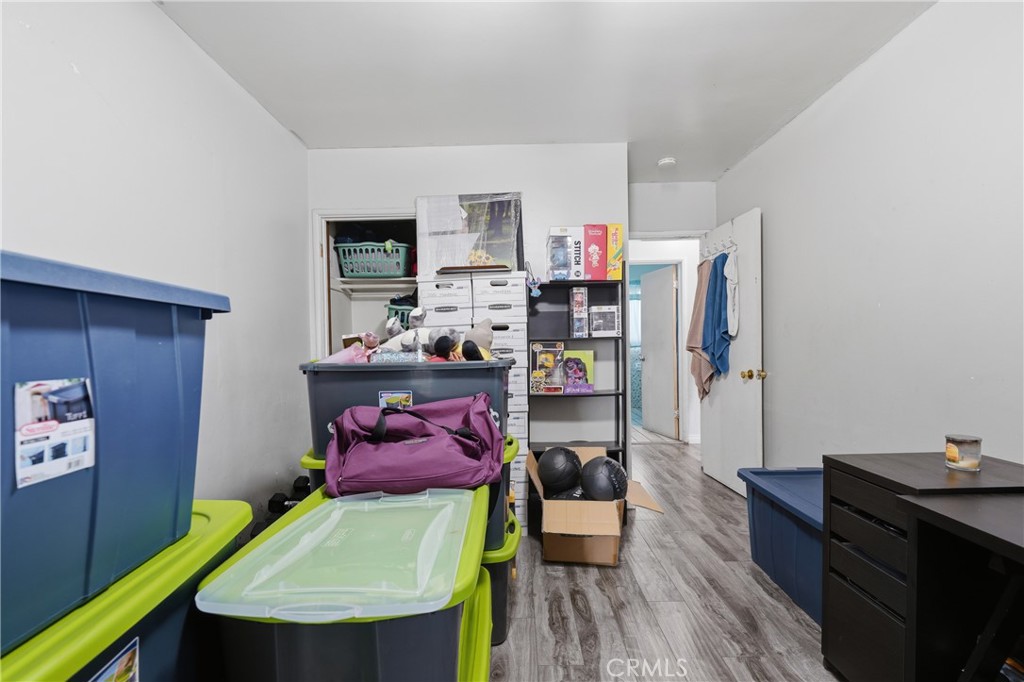 12817 Zeus Avenue Norwalk, CA 90650 - Photo 17 of 36 a room with furniture and wooden floor