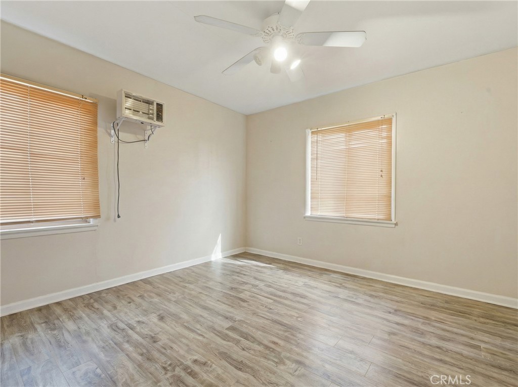 12817 Zeus Avenue Norwalk, CA 90650 - Photo 18 of 36 an empty room with wooden floor and windows