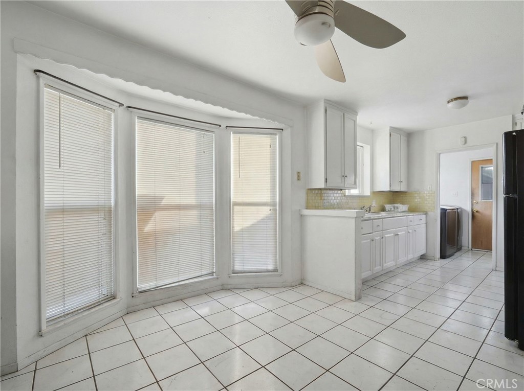 12817 Zeus Avenue Norwalk, CA 90650 - Photo 8 of 36 a kitchen with a refrigerator a sink and cabinets