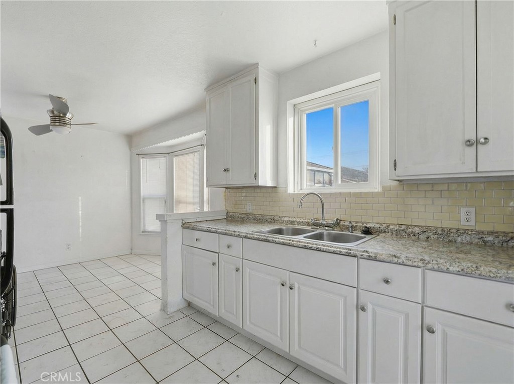 12817 Zeus Avenue Norwalk, CA 90650 - Photo 10 of 36 a kitchen with a sink and cabinets