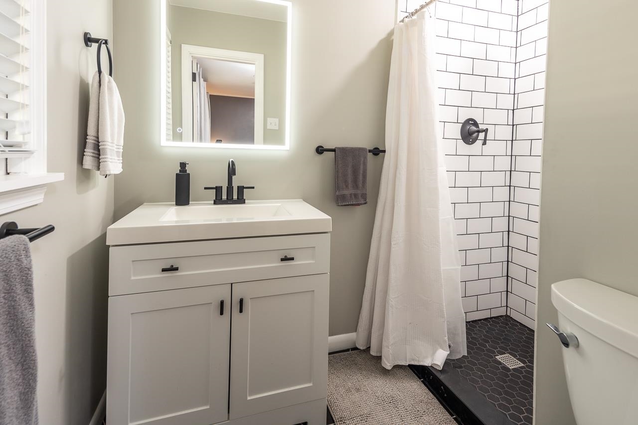 4983 Dee Road Memphis, TN 38117 - Photo 17 of 25 a bathroom with a sink a toilet and shower