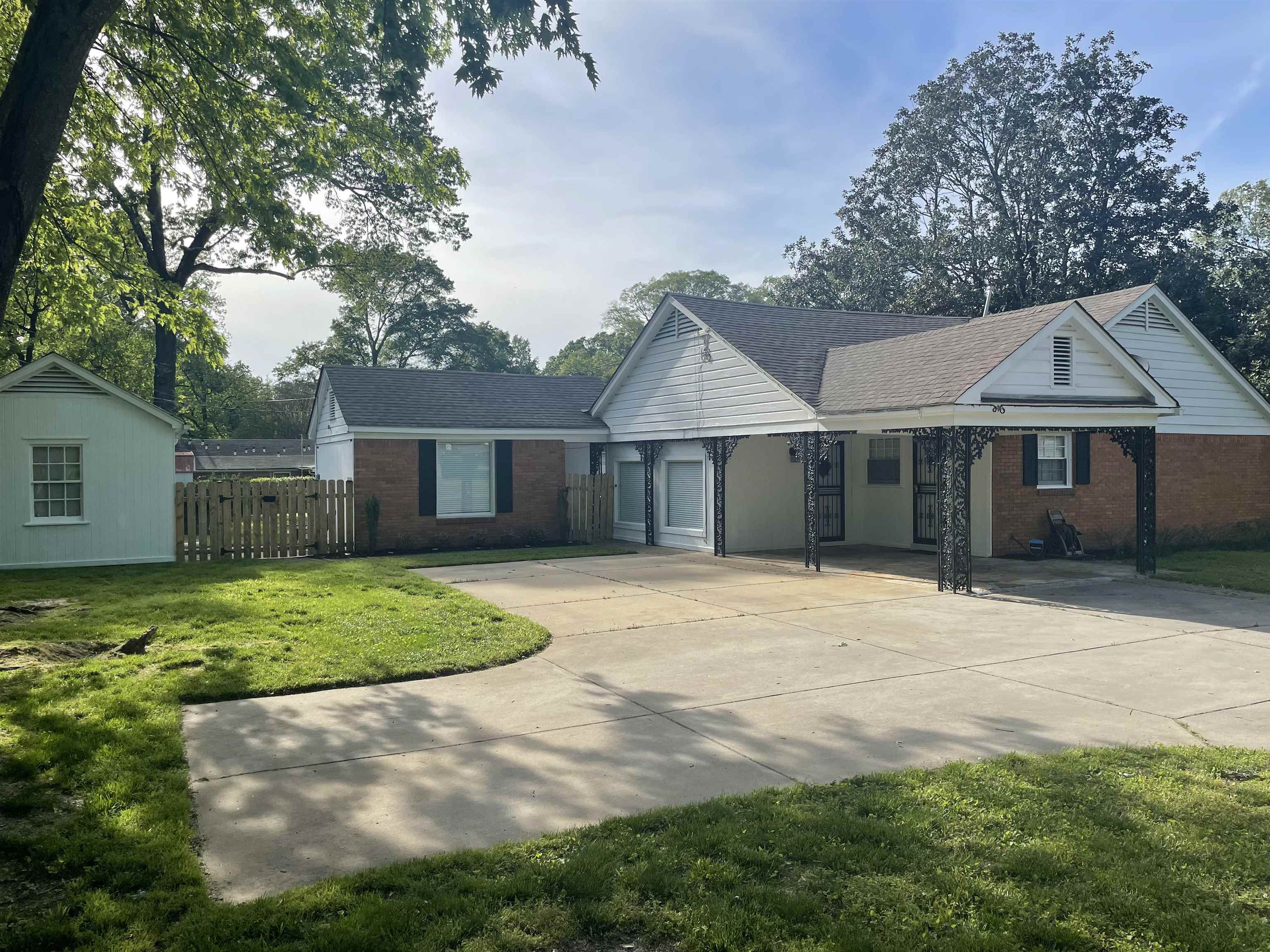 4983 Dee Road Memphis, TN 38117 - Photo 24 of 25 a front view of a house with a yard and trees
