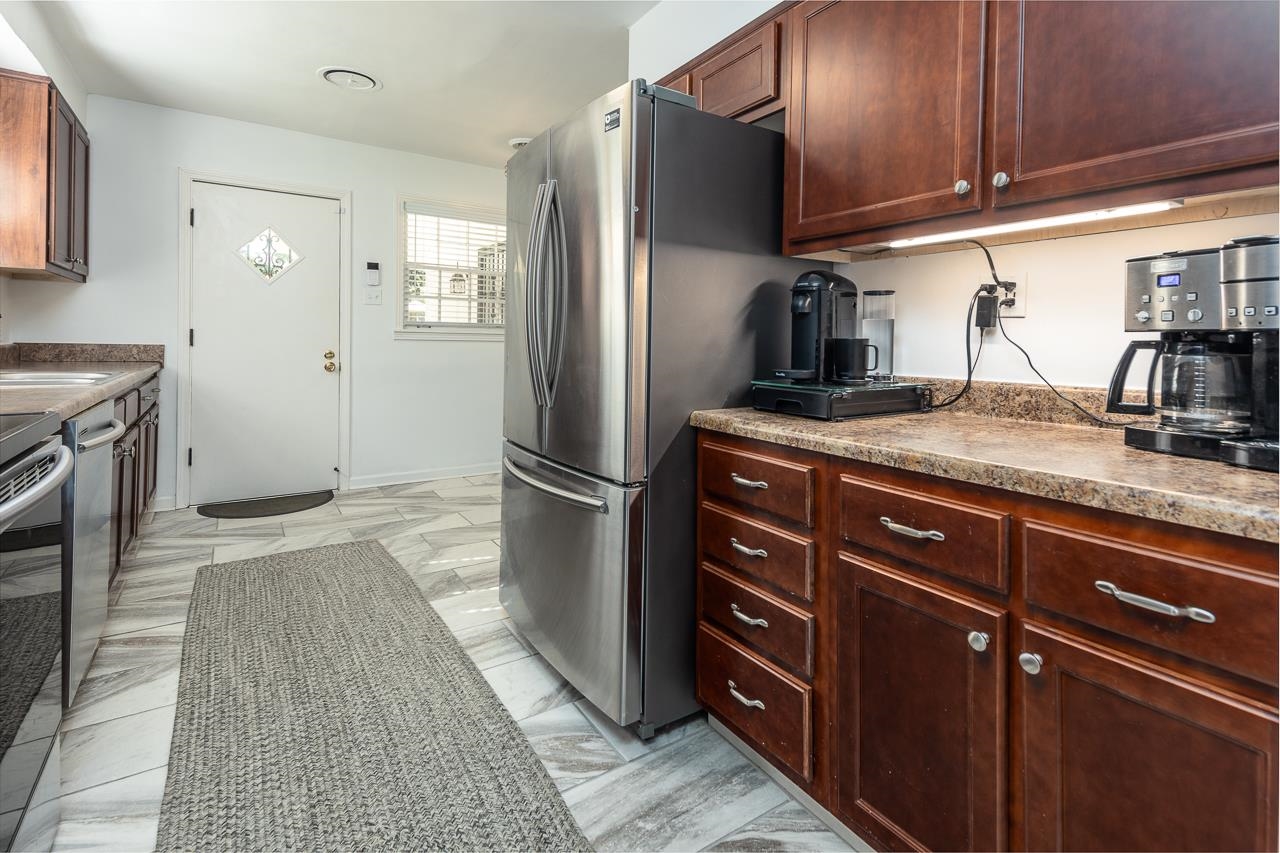 4983 Dee Road Memphis, TN 38117 - Photo 8 of 25 a kitchen with stainless steel appliances granite countertop a refrigerator and a sink