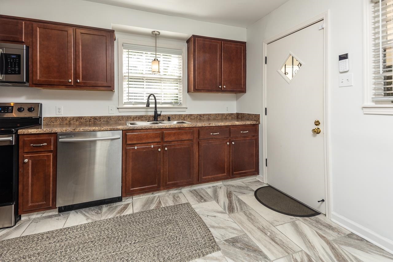 4983 Dee Road Memphis, TN 38117 - Photo 9 of 25 a kitchen with a sink cabinets and window