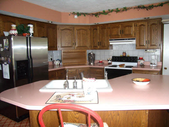 12233 Beaverton Road Poplar Grove, IL 61065 - Photo 4 of 6 a kitchen with stainless steel appliances kitchen island granite countertop a dining table and chairs