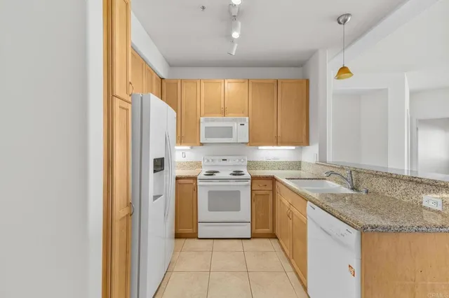 a kitchen with a sink stove and refrigerator