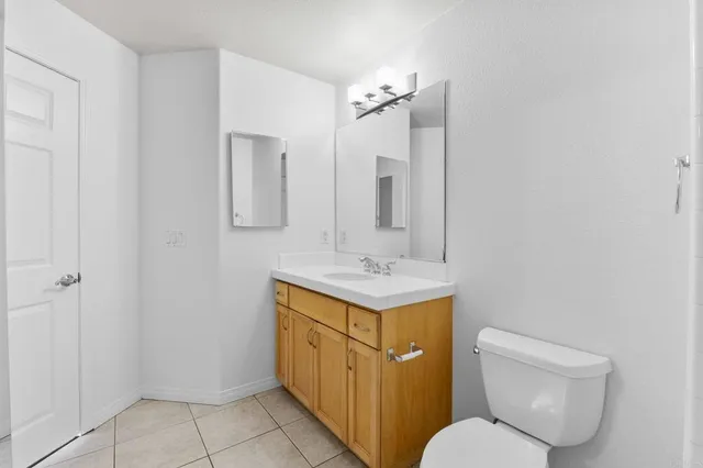 a bathroom with a toilet a sink and mirror