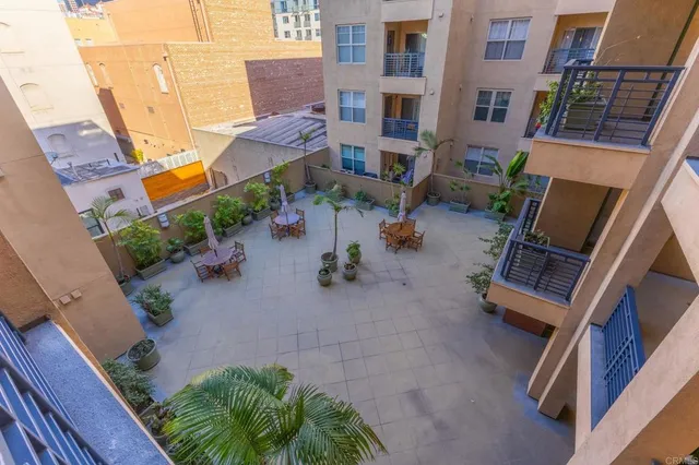 a view of a backyard with plants and a patio