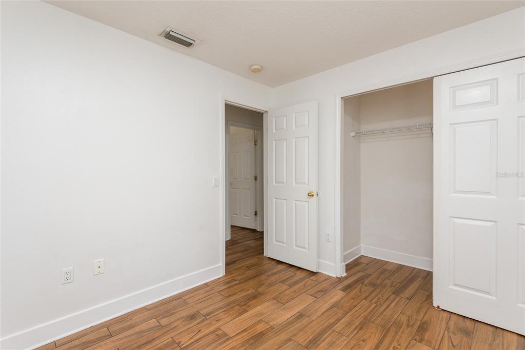 11813 Prickly Pear Way Seffner, FL 33584 - Photo 17 of 24 a view of an empty room with wooden floor