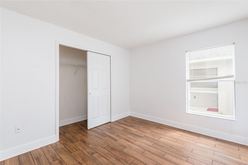 11813 Prickly Pear Way Seffner, FL 33584 - Photo 18 of 24 a view of empty room with wooden floor and fan