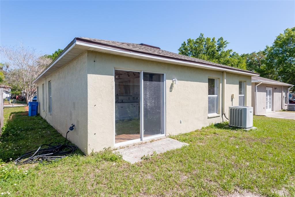 11813 Prickly Pear Way Seffner, FL 33584 - Photo 23 of 24 a backyard of a house with plants and barbeque oven