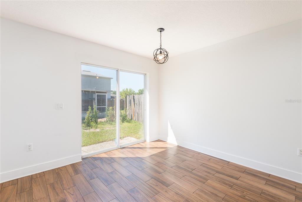 11813 Prickly Pear Way Seffner, FL 33584 - Photo 9 of 24 a view of empty room with wooden floor and fan