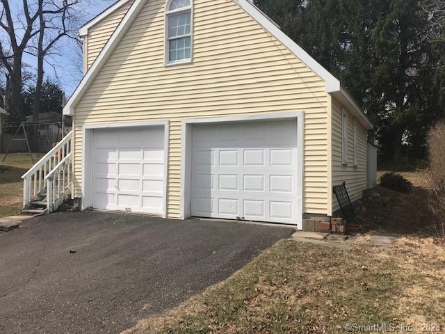 19 Greenfield Avenue Ridgefield, CT 06877 - Photo 14 of 28 a front view of a house with a yard and garage