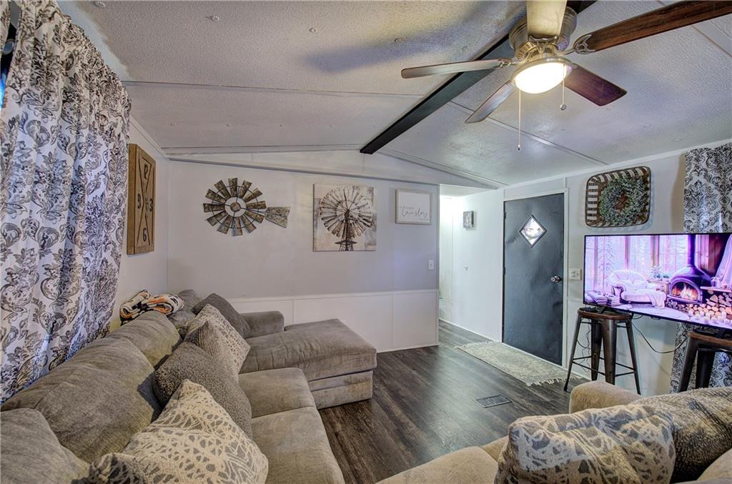 676 Flowery Branch Road Kingston, GA 30145 - Photo 11 of 96 a living room with furniture and a flat screen tv