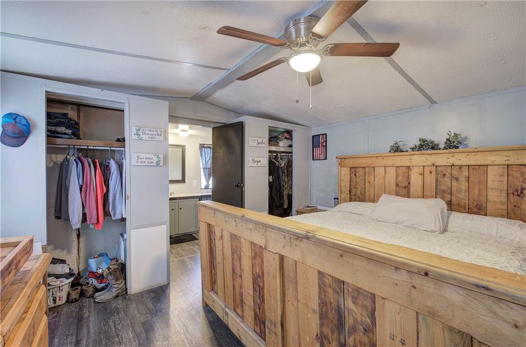 676 Flowery Branch Road Kingston, GA 30145 - Photo 19 of 96 a bedroom with a bed and a chandelier