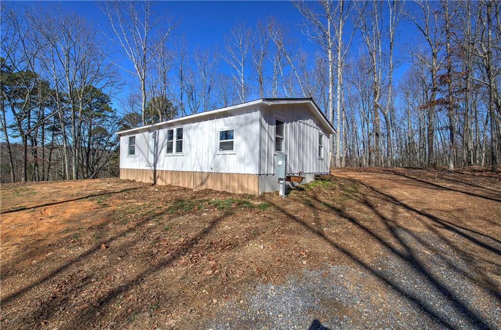676 Flowery Branch Road Kingston, GA 30145 - Photo 2 of 96 a house view with a backyard