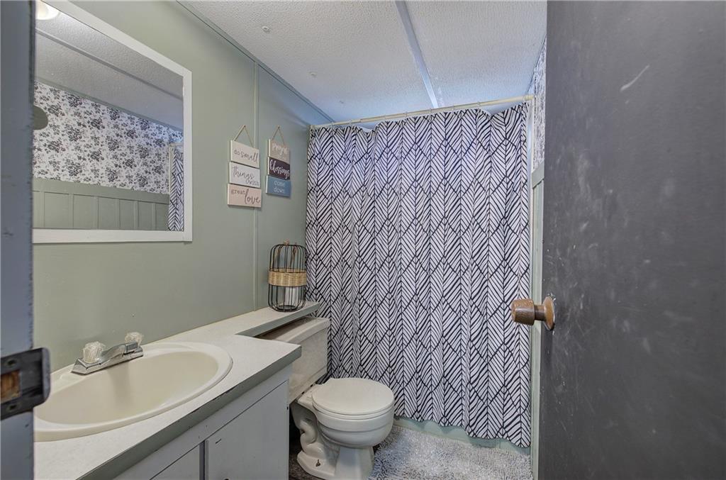 676 Flowery Branch Road Kingston, GA 30145 - Photo 25 of 96 a bathroom with a sink toilet and shower