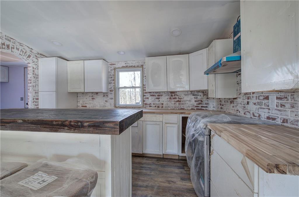 676 Flowery Branch Road Kingston, GA 30145 - Photo 33 of 96 a kitchen with a sink stove and cabinets