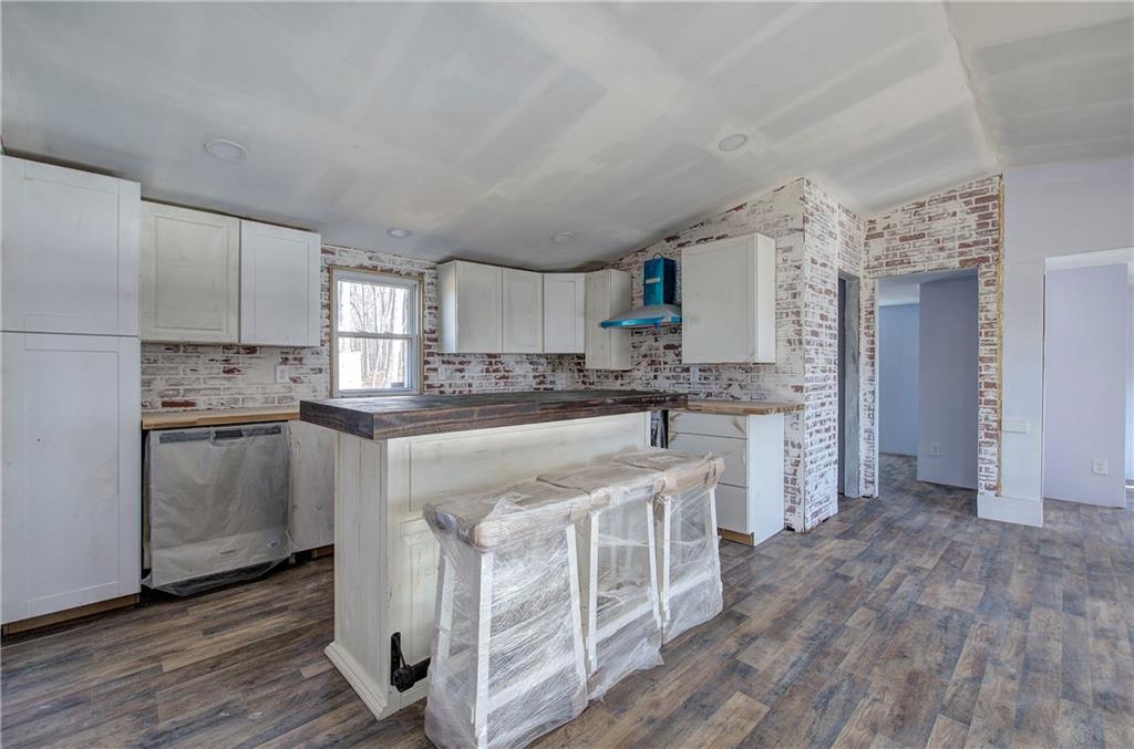 676 Flowery Branch Road Kingston, GA 30145 - Photo 35 of 96 a kitchen with white cabinets and stainless steel appliances