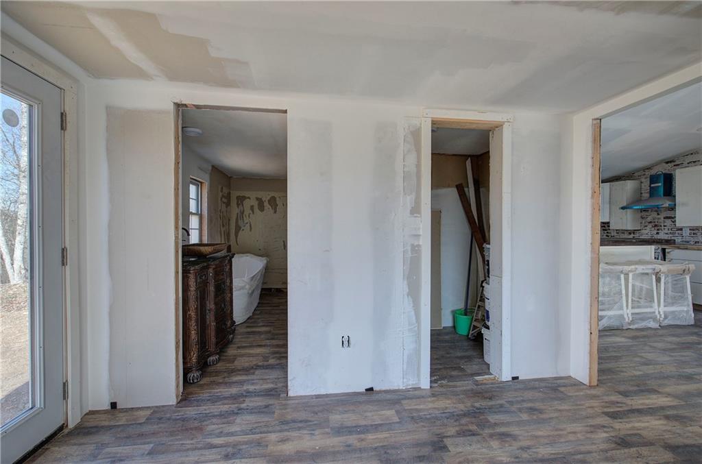 676 Flowery Branch Road Kingston, GA 30145 - Photo 37 of 96 a view of a hallway with dining room and wooden floor