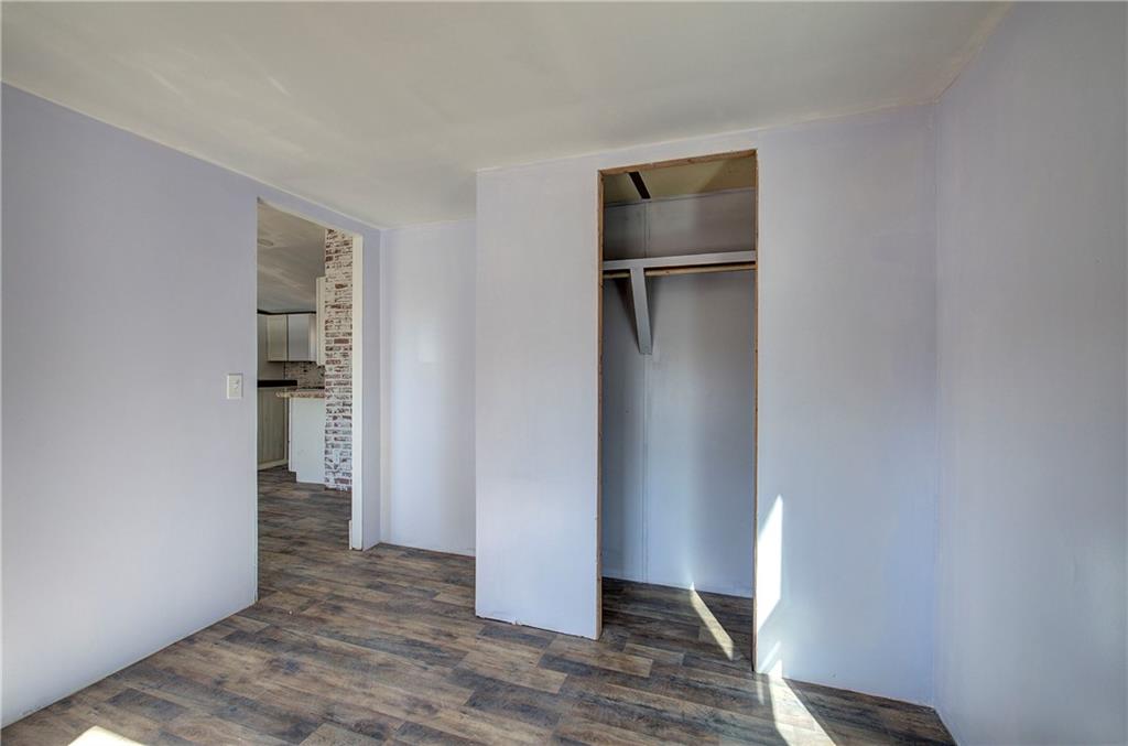 676 Flowery Branch Road Kingston, GA 30145 - Photo 41 of 96 a view of an empty room with wooden floor and closet