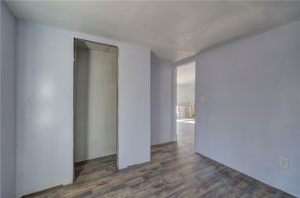 676 Flowery Branch Road Kingston, GA 30145 - Photo 44 of 96 a view of an empty room with wooden floor and a window
