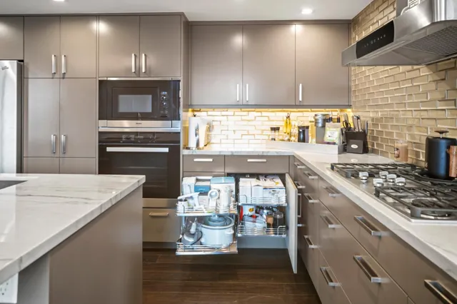 a kitchen with a stove a sink and a refrigerator
