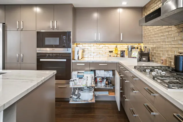a kitchen with a stove a sink and a refrigerator