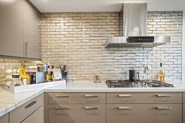a living room with furniture kitchen view and a flat screen tv
