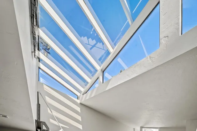a living room with furniture a fireplace and a large window