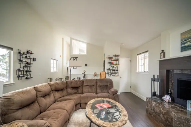 a view of a livingroom with wooden floor and stairs