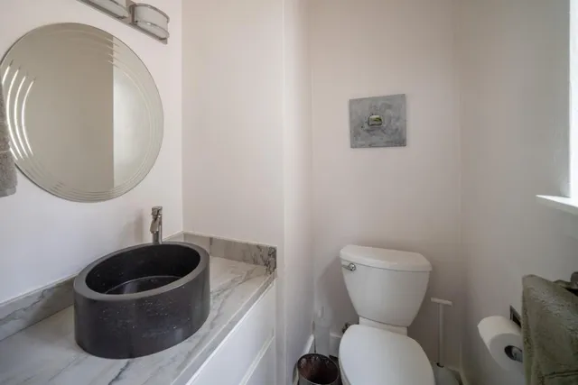 a bedroom with a bed and large window