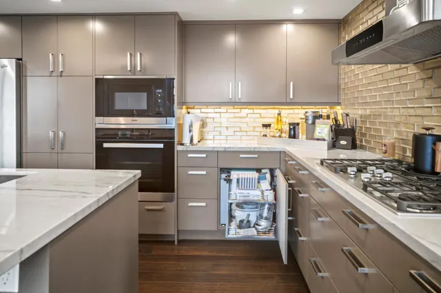 a kitchen with a stove a sink and a refrigerator