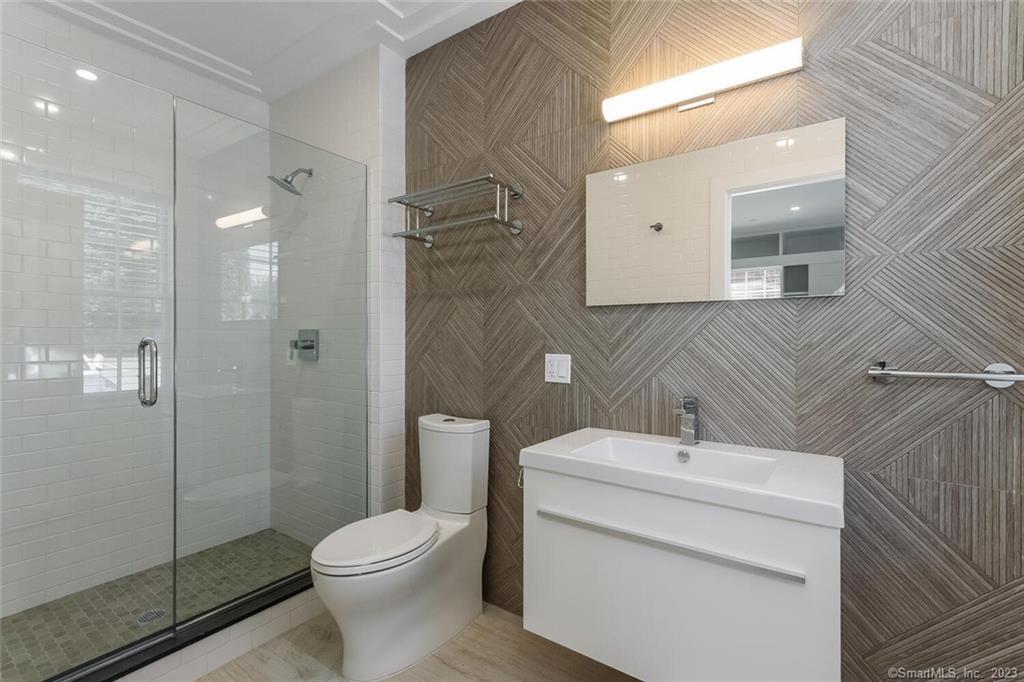 1990 Bronson Road, Unit 2 Fairfield, CT 06824 - Photo 11 of 33 a bathroom with a sink toilet and shower