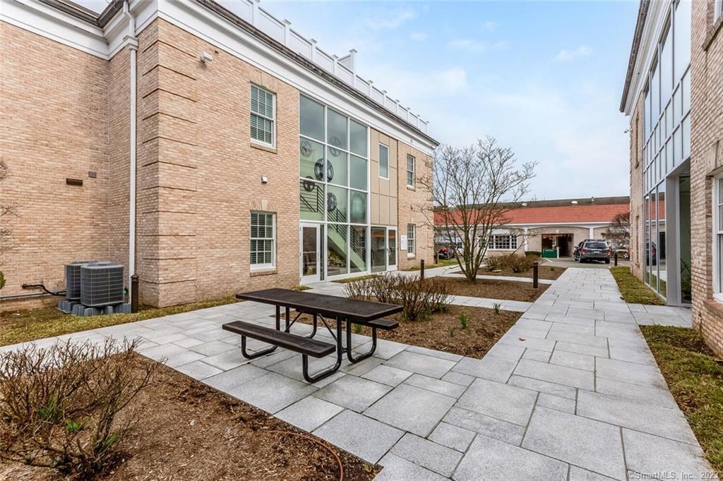 1990 Bronson Road, Unit 2 Fairfield, CT 06824 - Photo 23 of 33 a building exterior with furniture