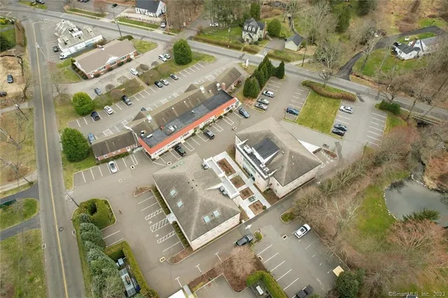 an aerial view of a house with a yard