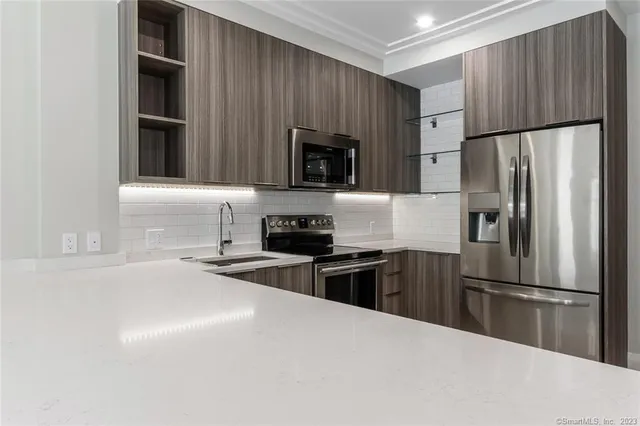 a kitchen with a refrigerator sink and microwave