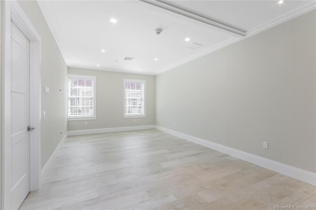 1990 Bronson Road, Unit 2 Fairfield, CT 06824 - Photo 7 of 33 an empty room with windows