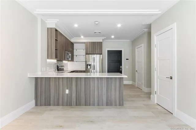 a kitchen with stainless steel appliances a refrigerator and a sink