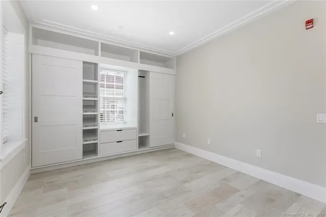 an empty room with closet and cabinet