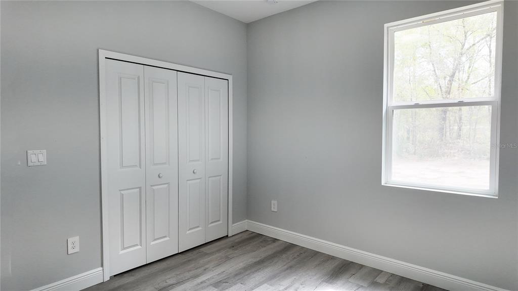 7 Spring Pass Ocala, FL 34472 - Photo 30 of 35 an empty room with wooden floor and windows