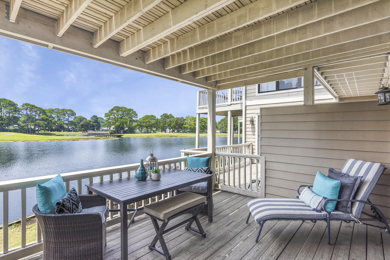 906 Harbour Point Lane, Unit 906 Miramar Beach, FL 32550 - Photo 2 of 36 a roof deck with a table and chairs