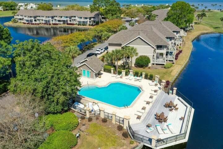 906 Harbour Point Lane, Unit 906 Miramar Beach, FL 32550 - Photo 23 of 36 an aerial view of a house with outdoor space swimming pool patio and lake view