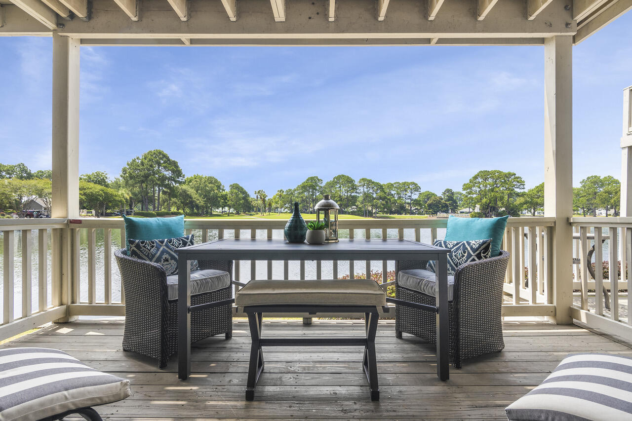 906 Harbour Point Lane, Unit 906 Miramar Beach, FL 32550 - Photo 4 of 36 a view of a deck with two chair and wooden floor