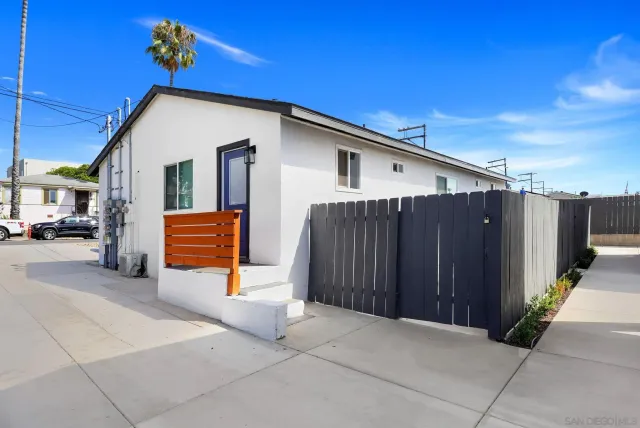 a view of a house with wooden fence
