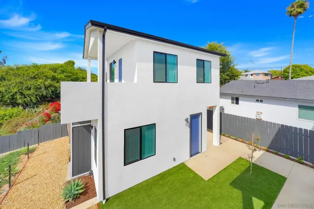 a view of a backyard with plants and a patio