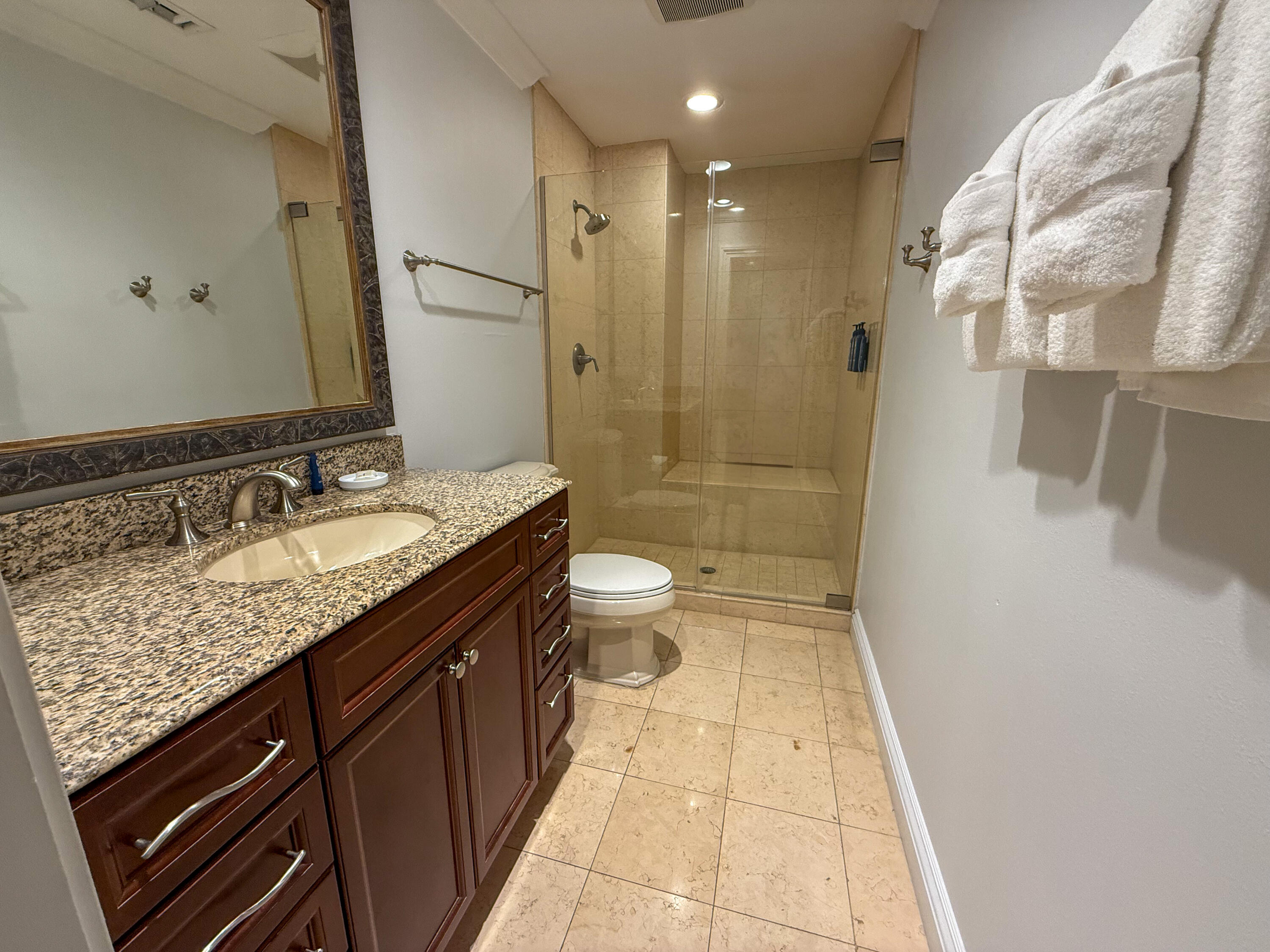 10 Harbor Boulevard, Unit E205H Destin, FL 32541 - Photo 15 of 30 a bathroom with a granite countertop sink a toilet a mirror and shower
