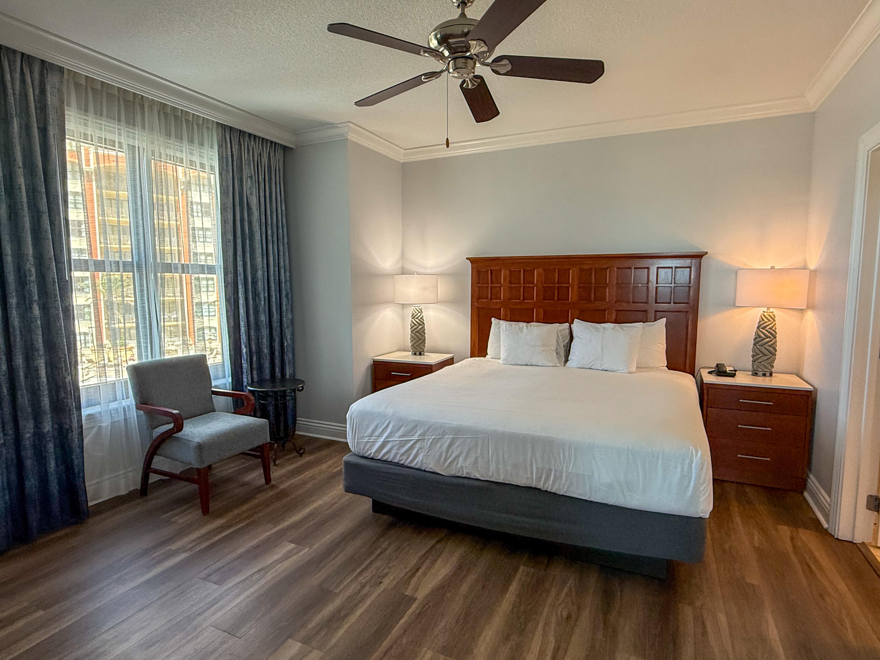 10 Harbor Boulevard, Unit E205H Destin, FL 32541 - Photo 16 of 30 a bedroom with a bed and wooden floor